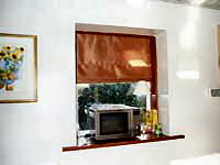 Roman blind in recessed window frame.