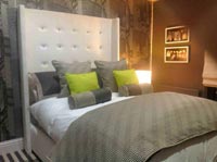 Padded throwover bedspread with contrasting cushion covers.