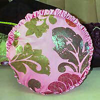 Cushion cover circular with outer frilling.