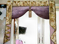 Padded silk pelmet with contrast rouching on top and side tails.