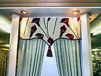 Shaped stiffened pelmet with cord and tasseles.